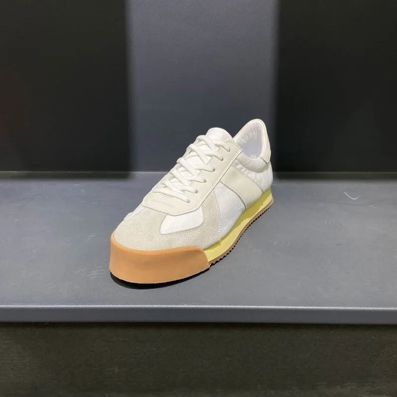 Men's grey suede and mesh sports shoe with a raised heel and herringbone pattern on the toe.