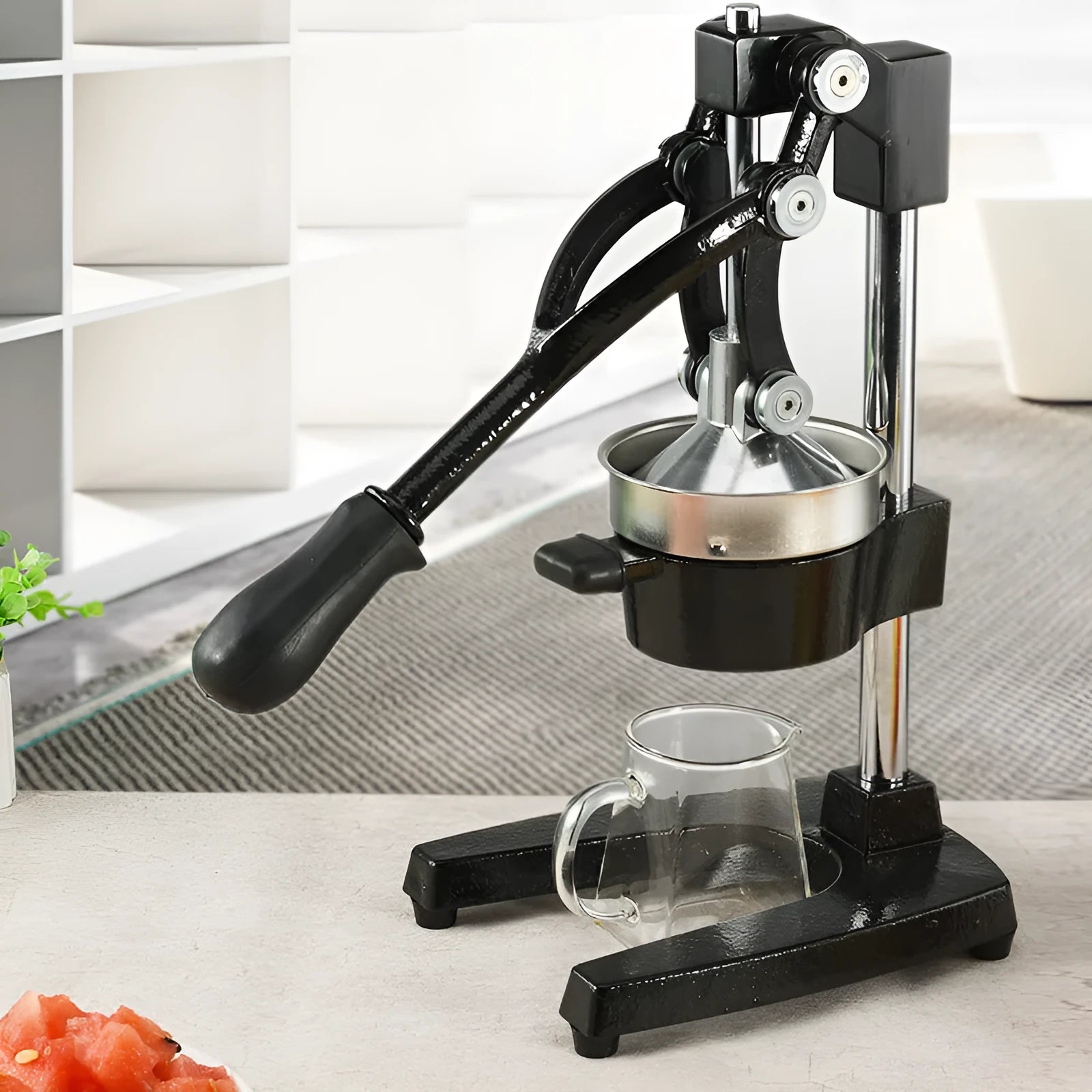 Black cast iron manual citrus juicer with stainless steel strainer, 40cm height