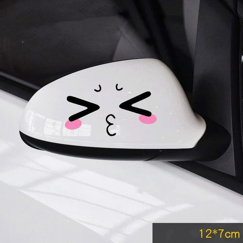 Pair of reflective cartoon eye car stickers on a vehicle rearview mirror and door panel.