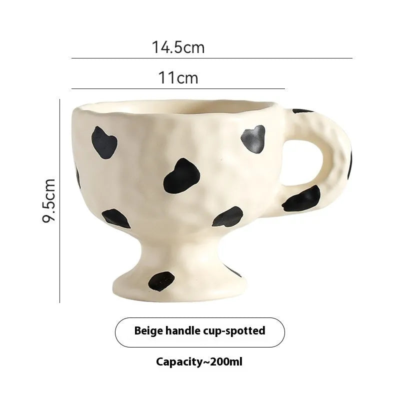 Hand-pinched irregular shaped ceramic mug in a solid colour on a plain background.