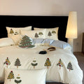 Cream blue duvet cover with raised towel embroidery of Christmas trees and flowers, part of a four-piece pure cotton bedding set.