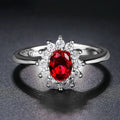 Women's blue moissanite and zirconium floral ring made from electroplated copper on a hand.