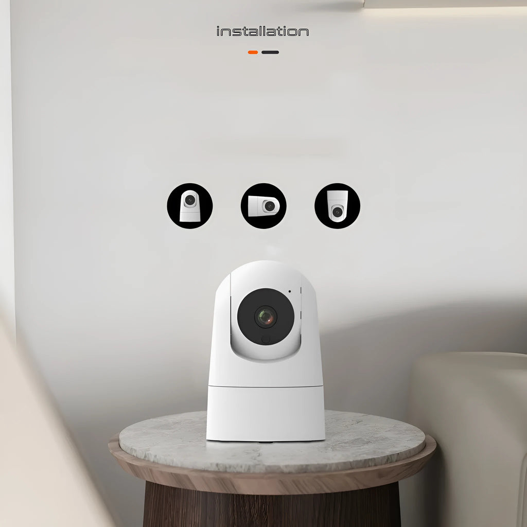 White indoor security camera with lens on a circular motorised base, showing compact size for shelf placement.
