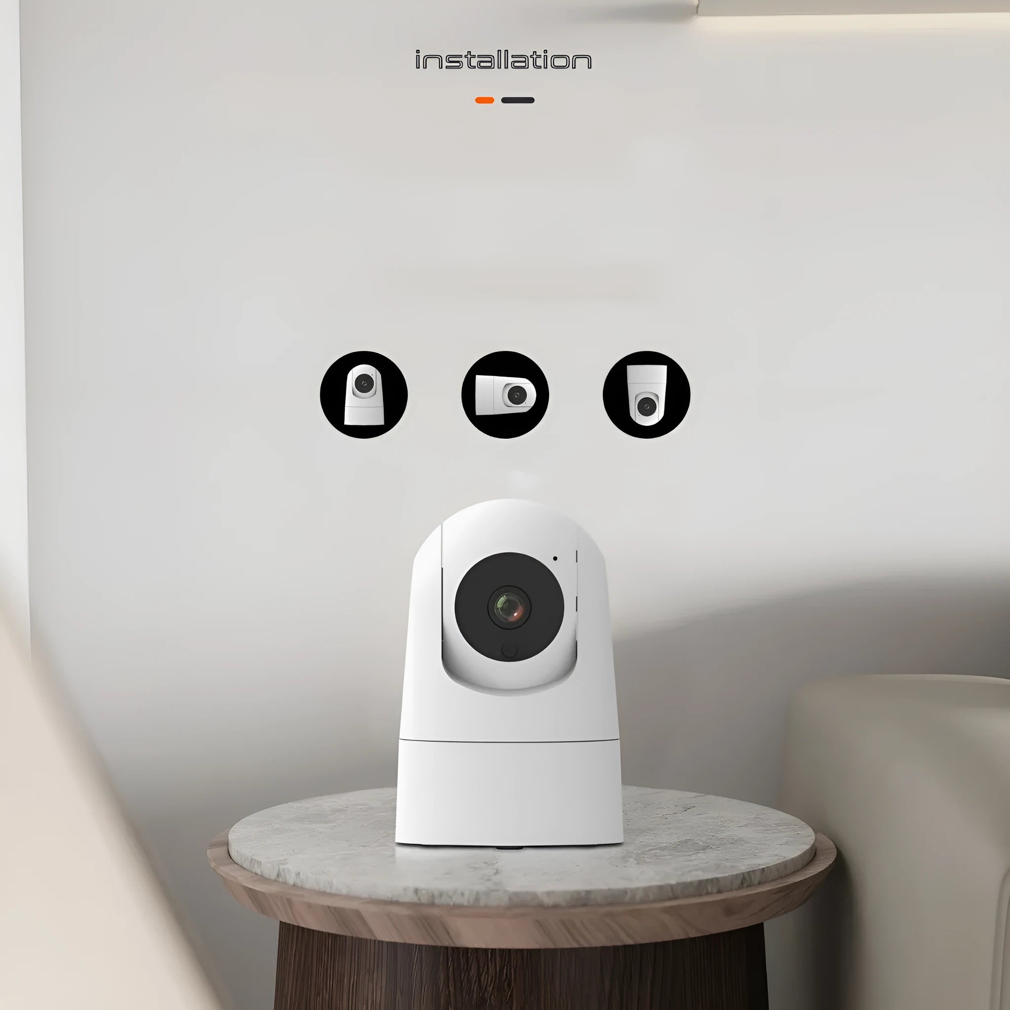 White indoor security camera with lens on a circular motorised base, showing compact size for shelf placement.