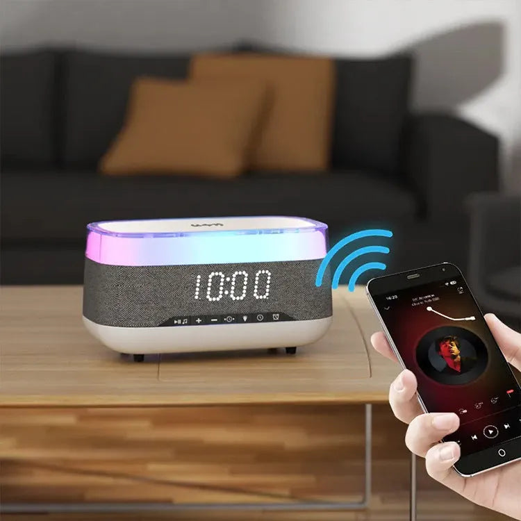 White multifunctional alarm clock with Bluetooth speaker and wireless charging pad showing night light illumination