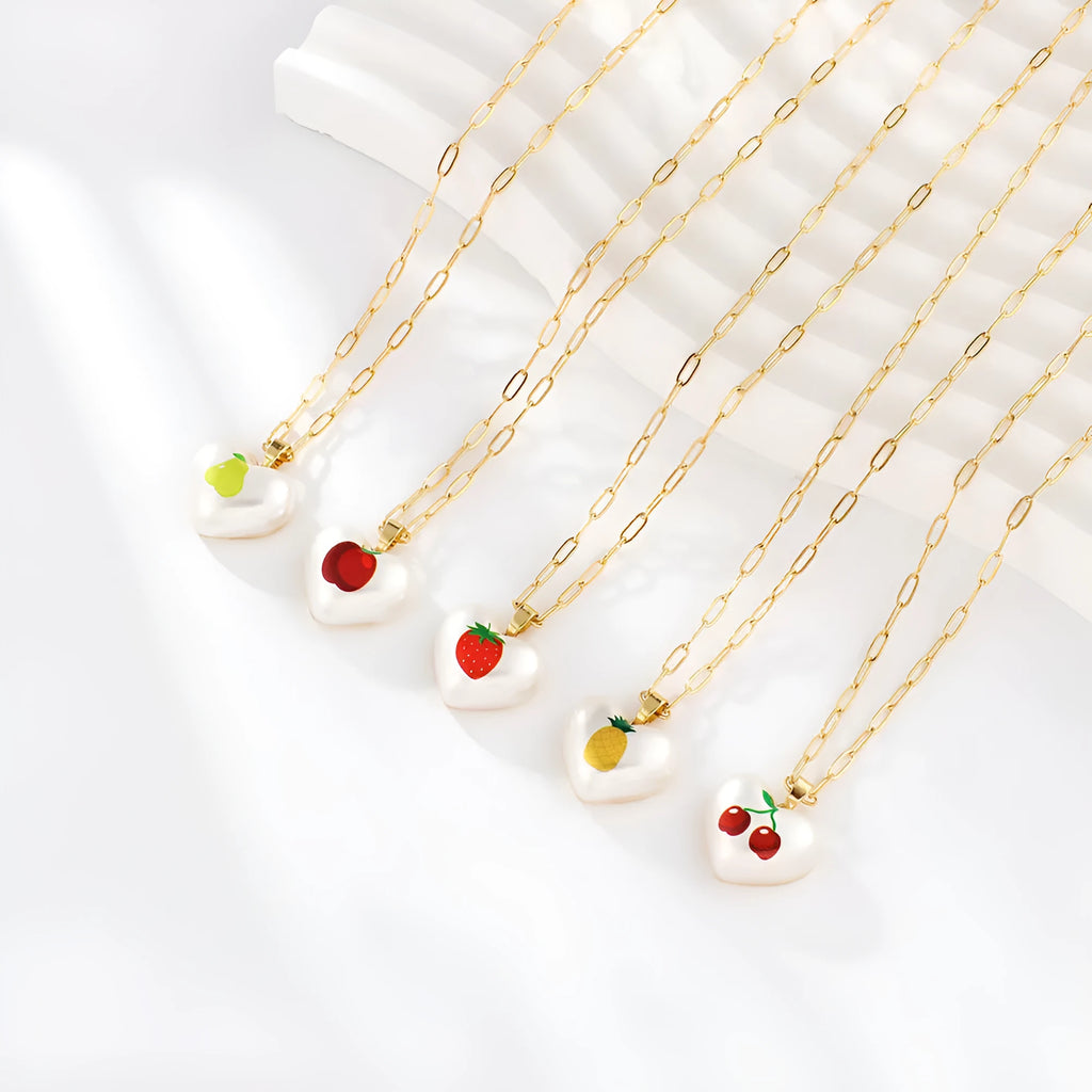 Geometric heart-shaped necklace with a detailed strawberry charm pendant on an adjustable chain.