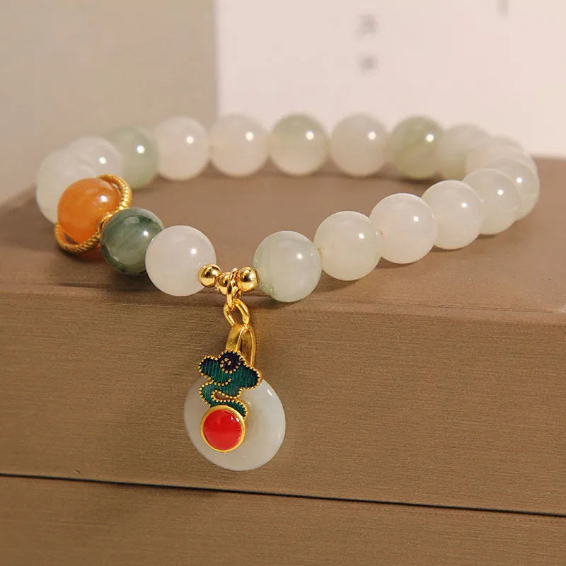 Women's ice jade crystal bracelet with a pearl and a detailed Xiangyun peace jade buckle.