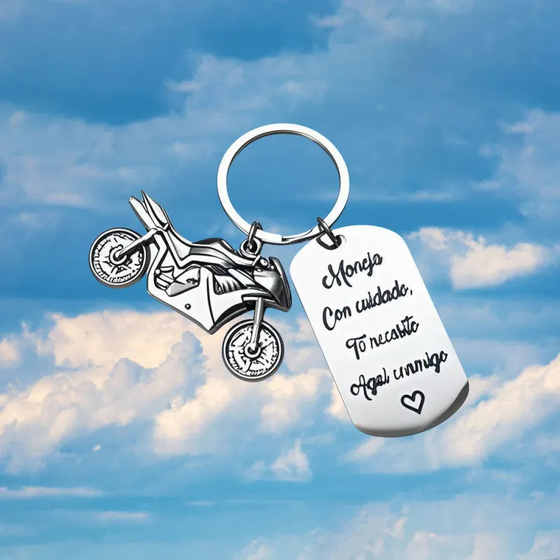 Stainless steel motivational keychain for motorcycle keys with a flannel storage bag.