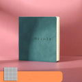 Square faux leather notebook open on a table, showing Daolin paper and French fold binding.