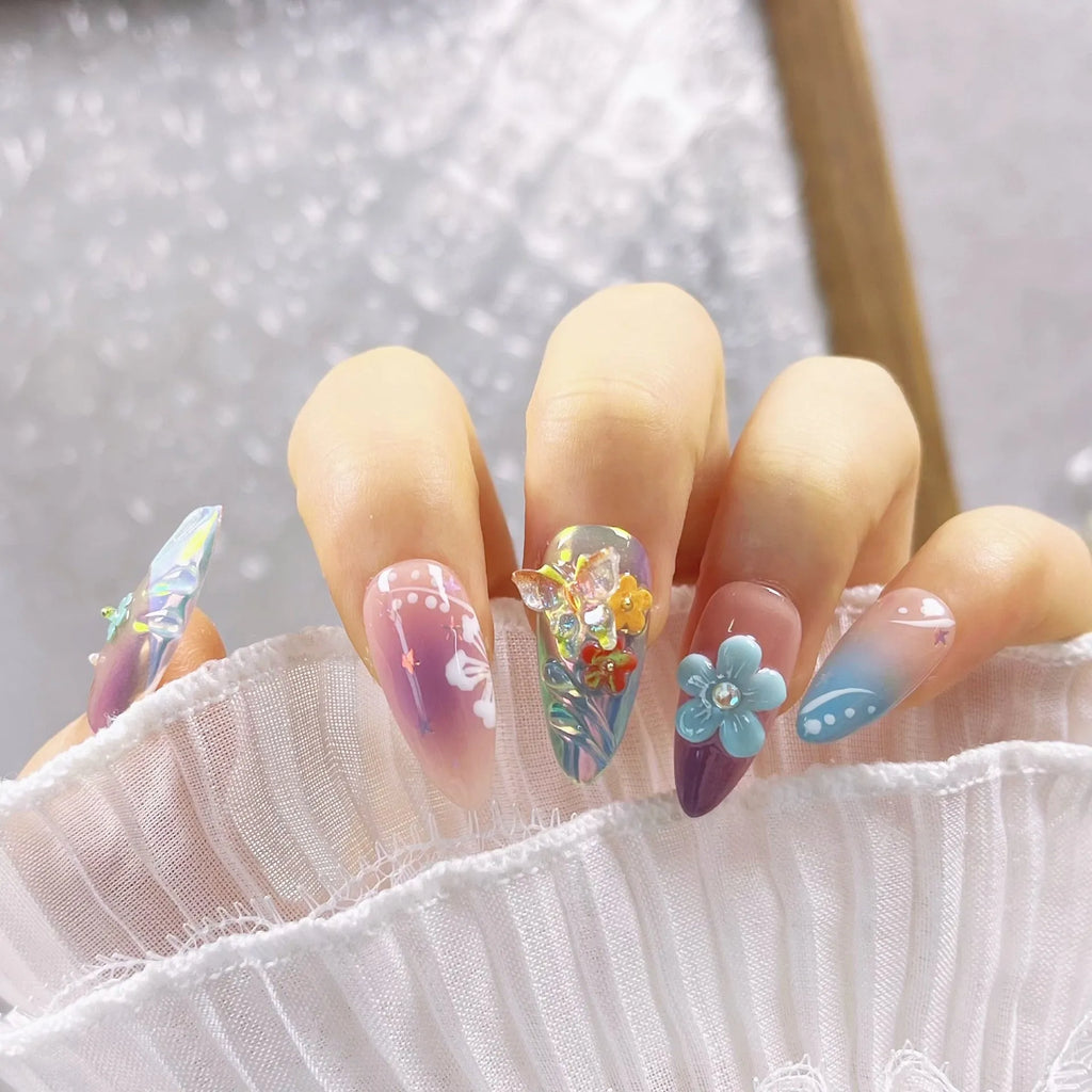 Handmade colourful embossed flower and butterfly nail art charms on a manicure set.