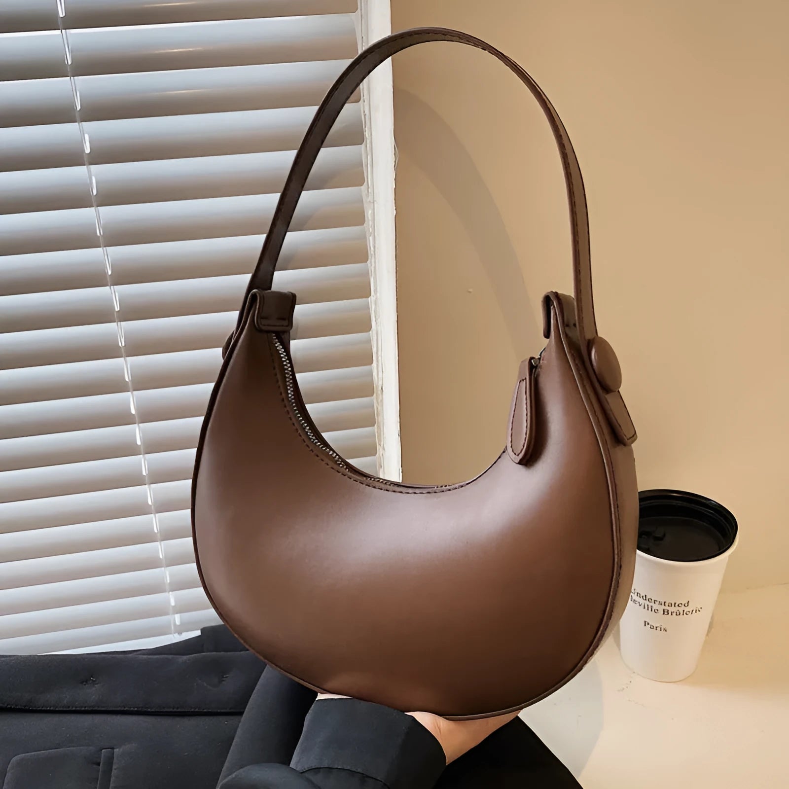 Women's retro-style PU leather shoulder bag in a dumpling shape, shown in black.