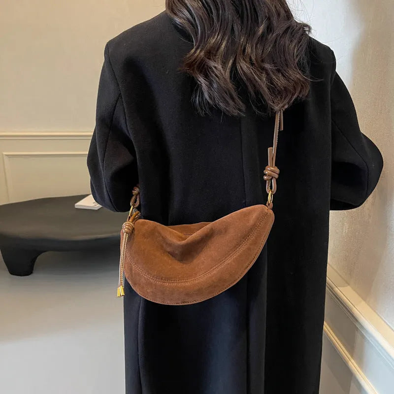 Soft PU crossbody underarm dumpling bag in black with visible sewing line detail