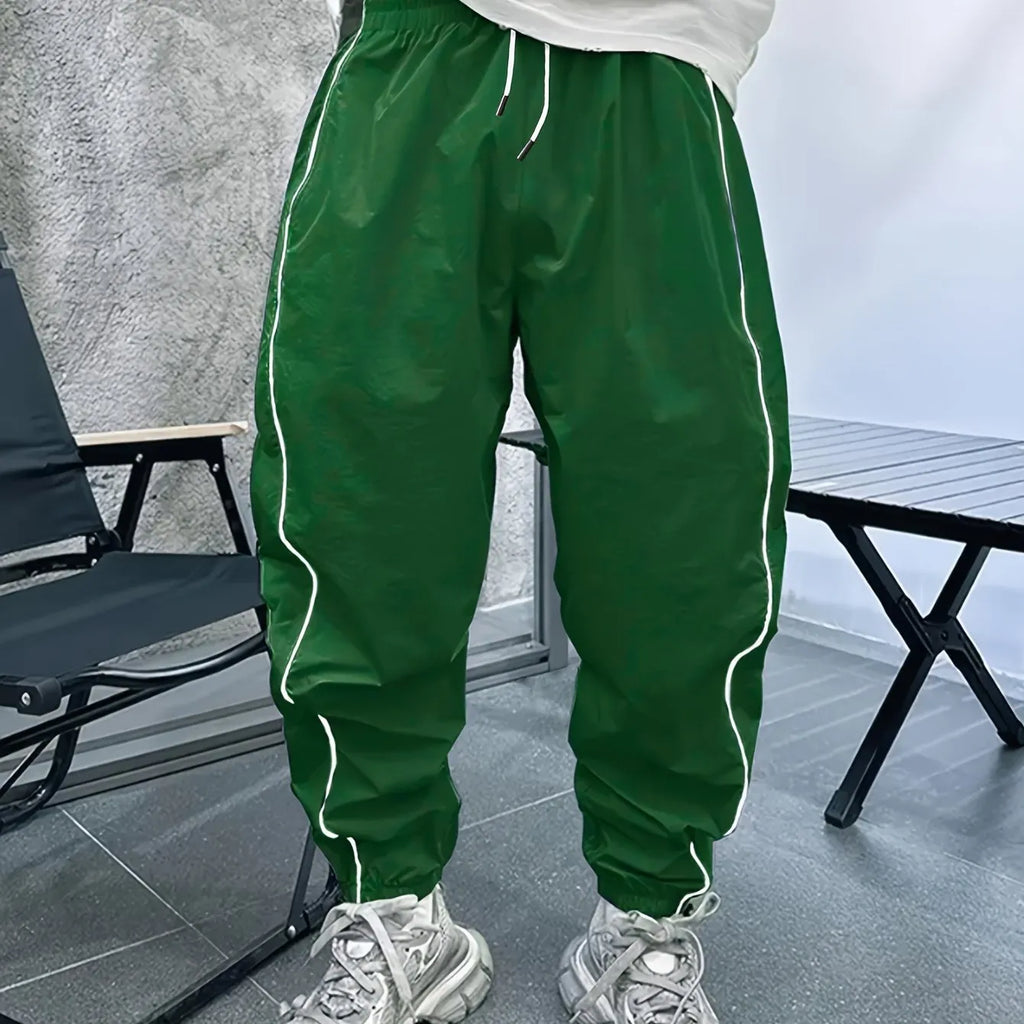 Men's blue bamboo fibre casual sports trousers with a loose, cropped fit on a neutral background.