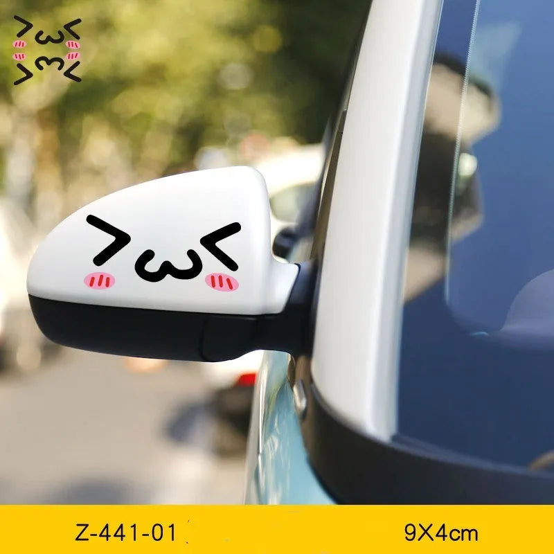 Pair of reflective cartoon eye car stickers on a vehicle rearview mirror and door panel.