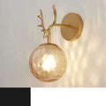 Round minimalist glass wall sconce with E27 bulb holder, shown in a black and golden finish, mounted on a plain wall.