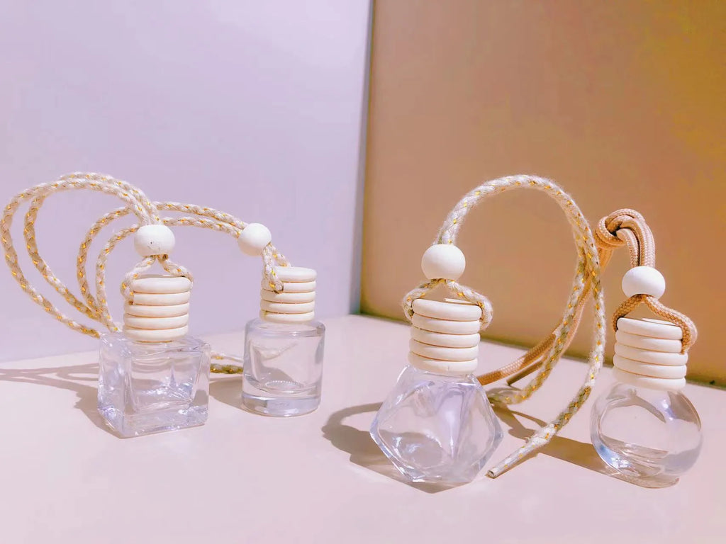 Glass car perfume pendant fragrance diffuser in cylinder, diamond, flat drum, and square styles.