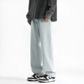 Men's light blue straight leg jeans with a button waist on a white background.