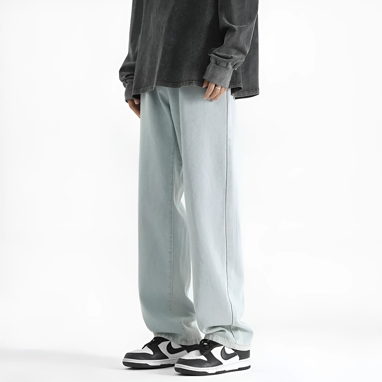 Men's light blue straight leg jeans with a button waist on a white background.