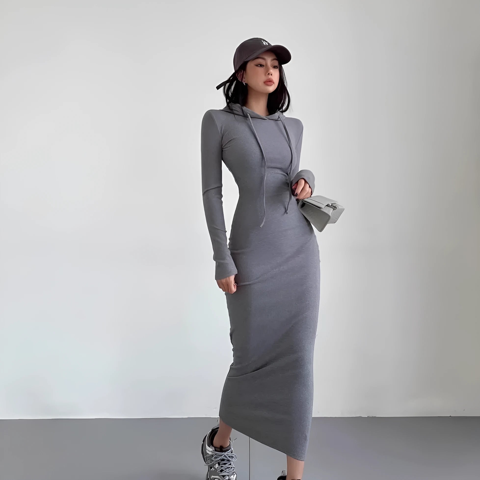 Women's light gray hooded sheath dress with long sleeves and a high waist on a hanger