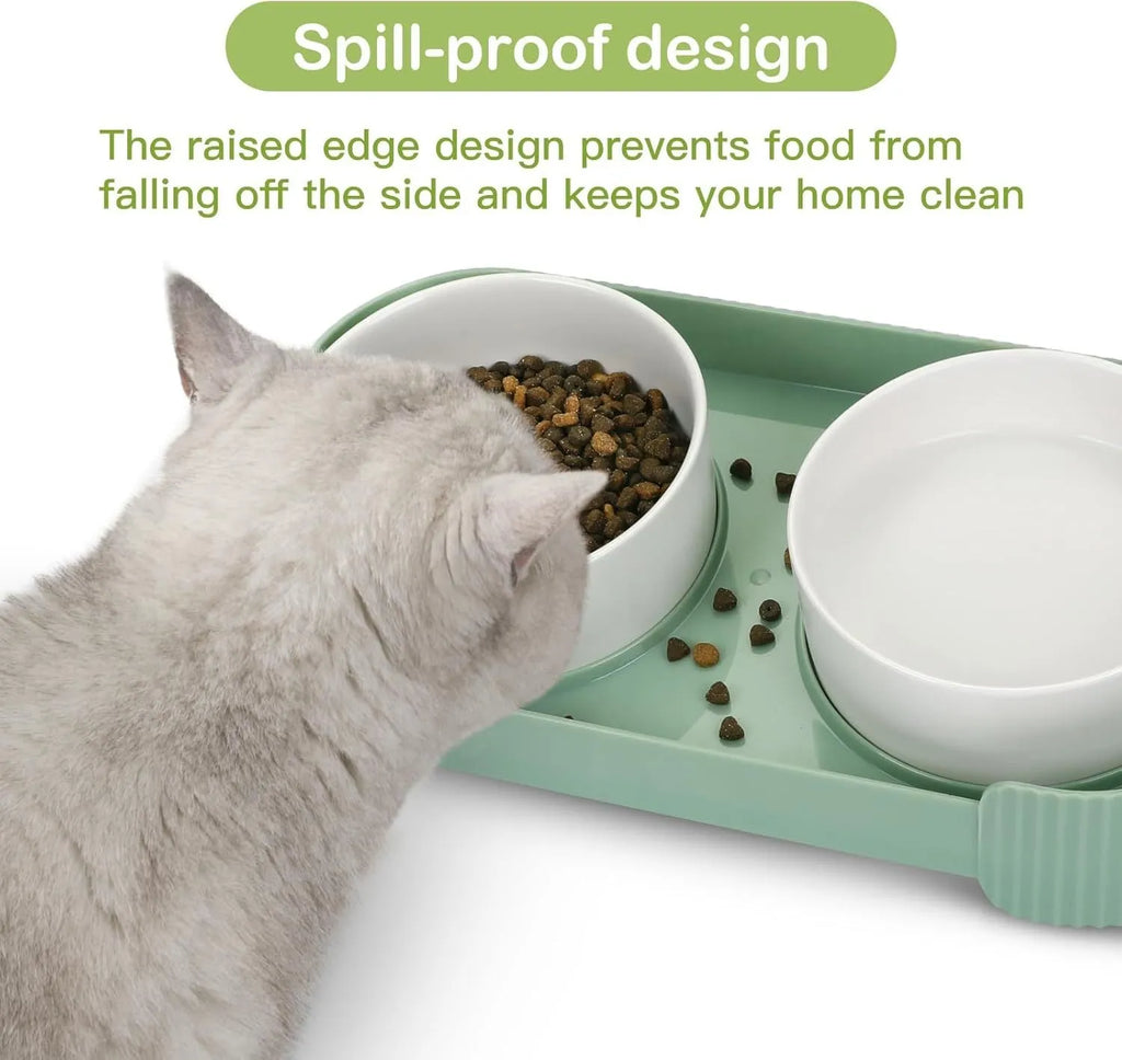 Green ceramic raised cat bowl set with two bowls on a tilted stand, showing non-slip base.