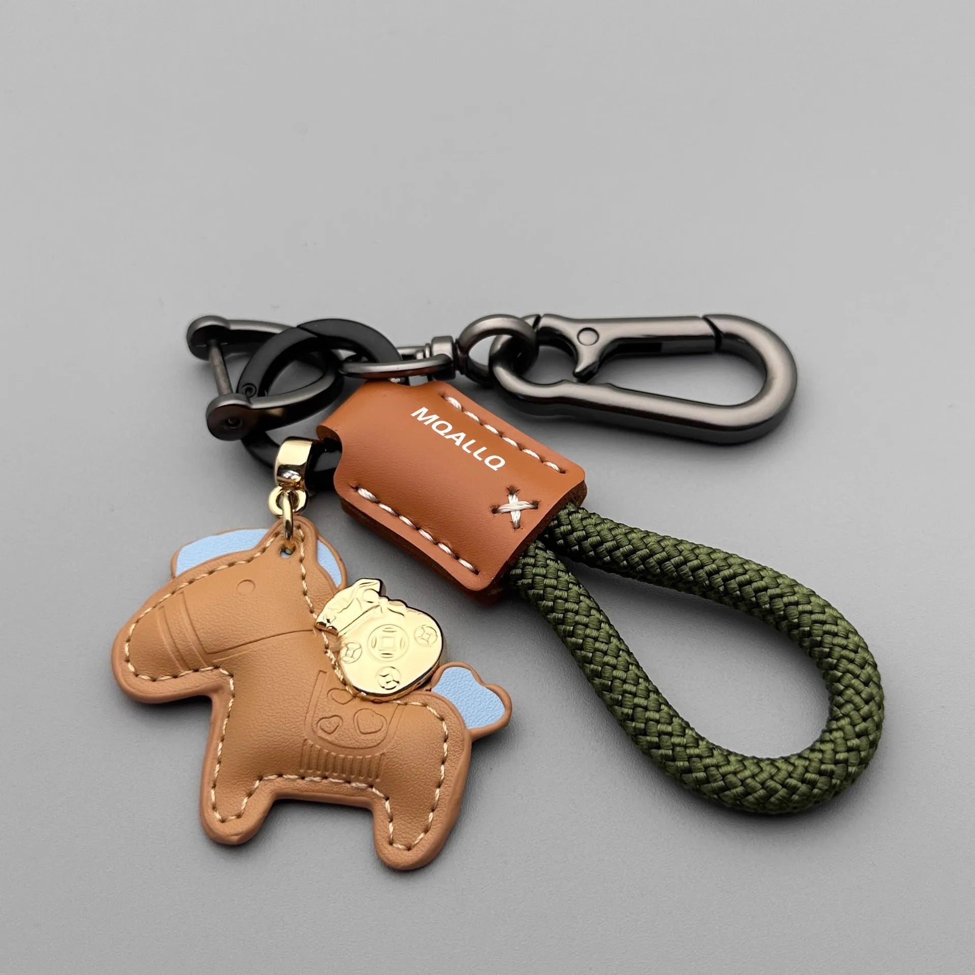 Handmade brown cowhide key ring pendant with zinc alloy pony buckle and green flanelle rope.