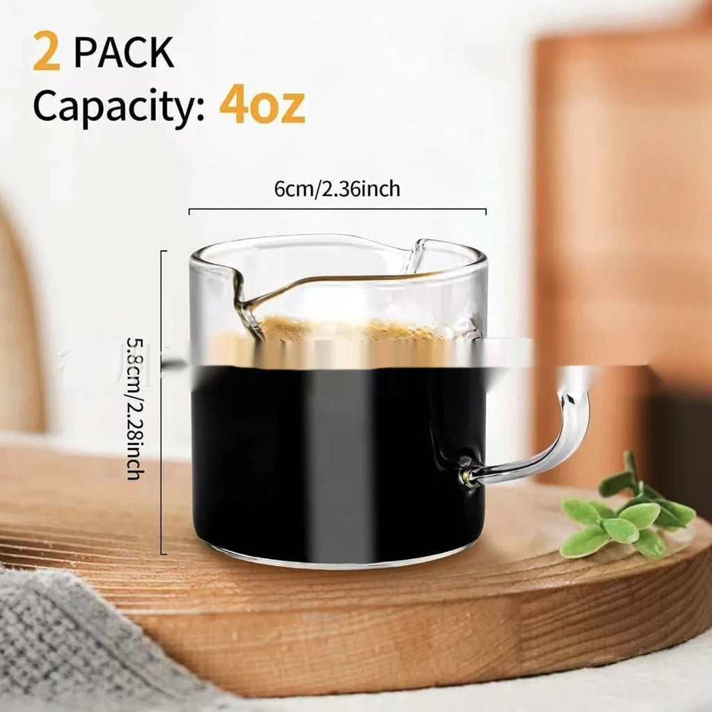 Set of white transparent glass double mouth coffee cups on a table.