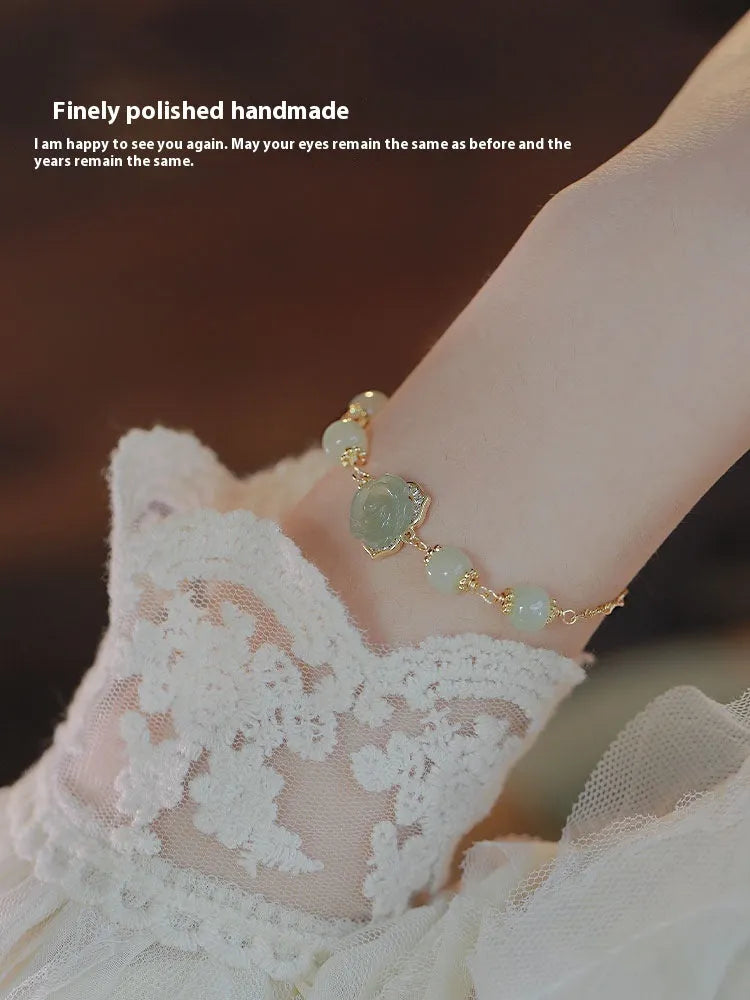 Women's jade bracelet with rose floral design and 14K gold gilding in Hetian Jade Rose colour.