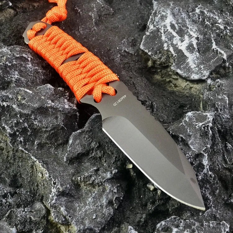 Straight camping survival knife with binding rope handle next to ABS sheath