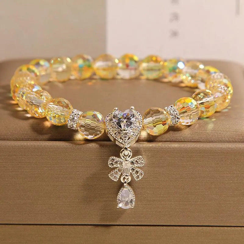 White crystal women's bracelet with butterfly and water drop charms on a metal chain, Japanese Korean style snowflake element.