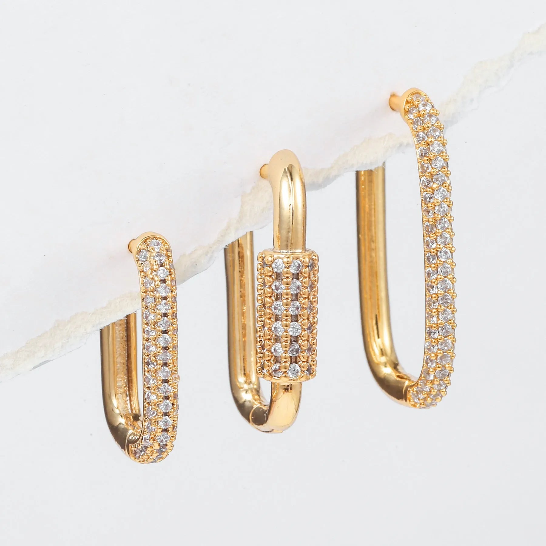 Geometric zircon ear clip set showing three square earrings with quadrilateral and ellipse designs