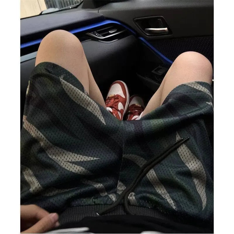 Men's straight leg camouflage mesh shorts in cotton blend fabric on a mannequin