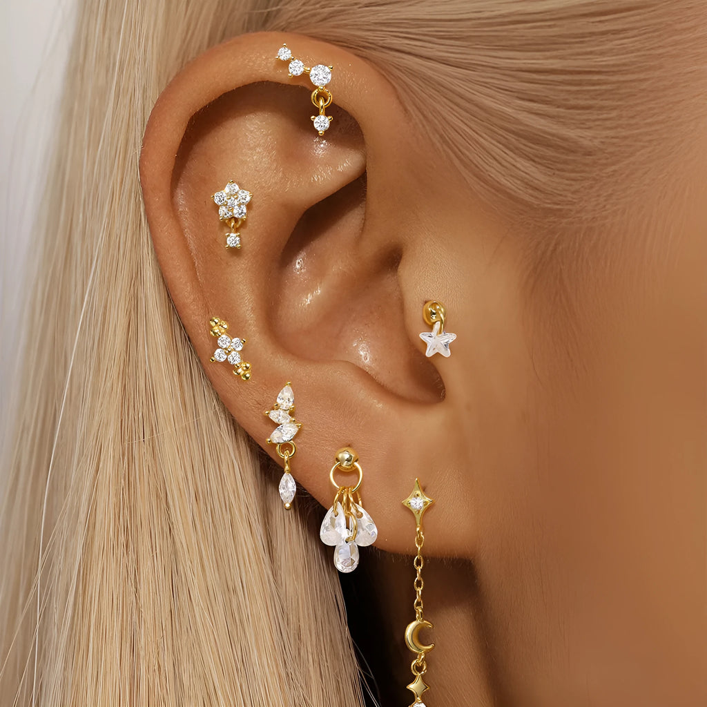 S925 sterling silver moon and star earrings with diamond accents on a gold-coloured background.