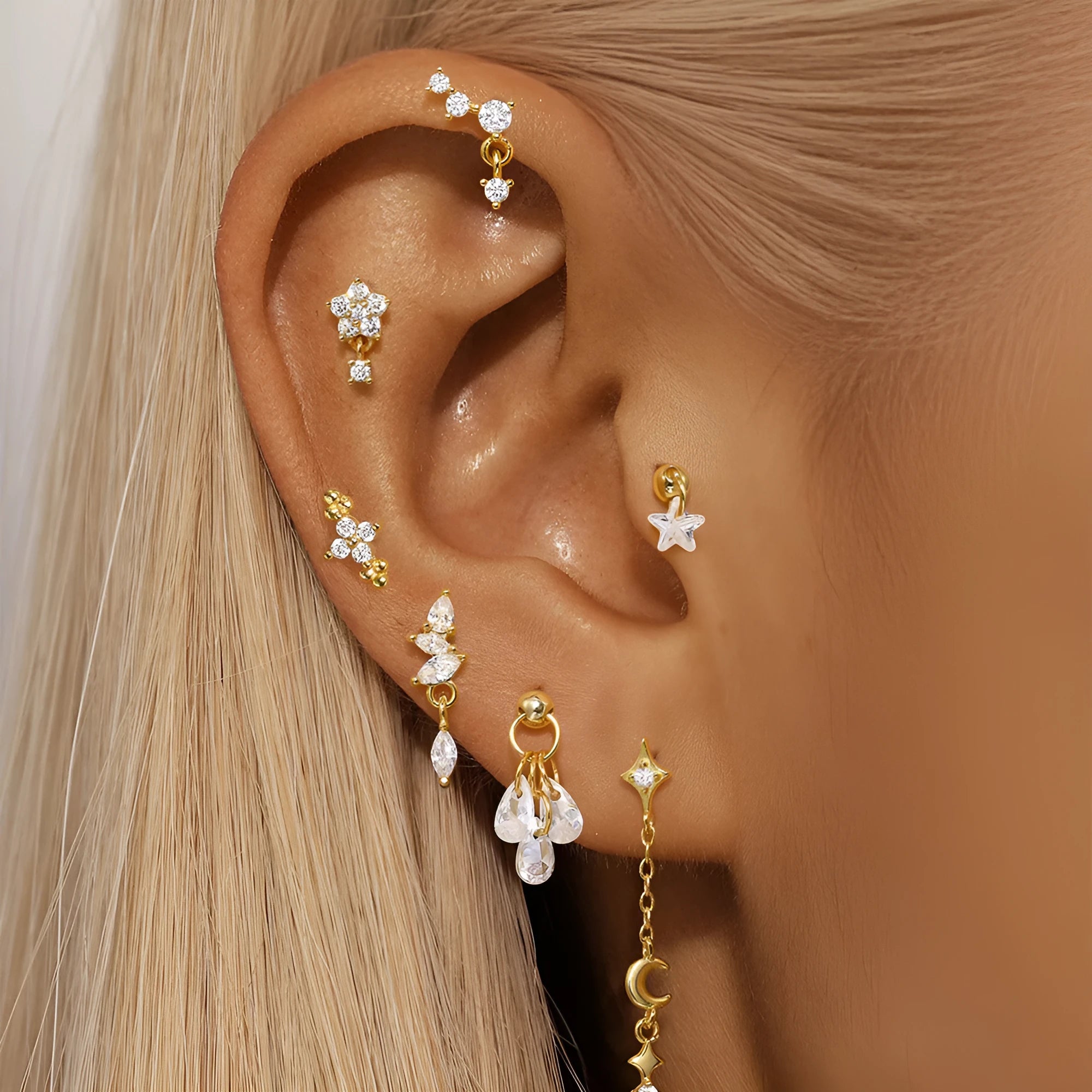 S925 sterling silver moon and star earrings with diamond accents on a gold-coloured background.