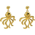 Gold stainless steel octopus drop earrings on a neutral background
