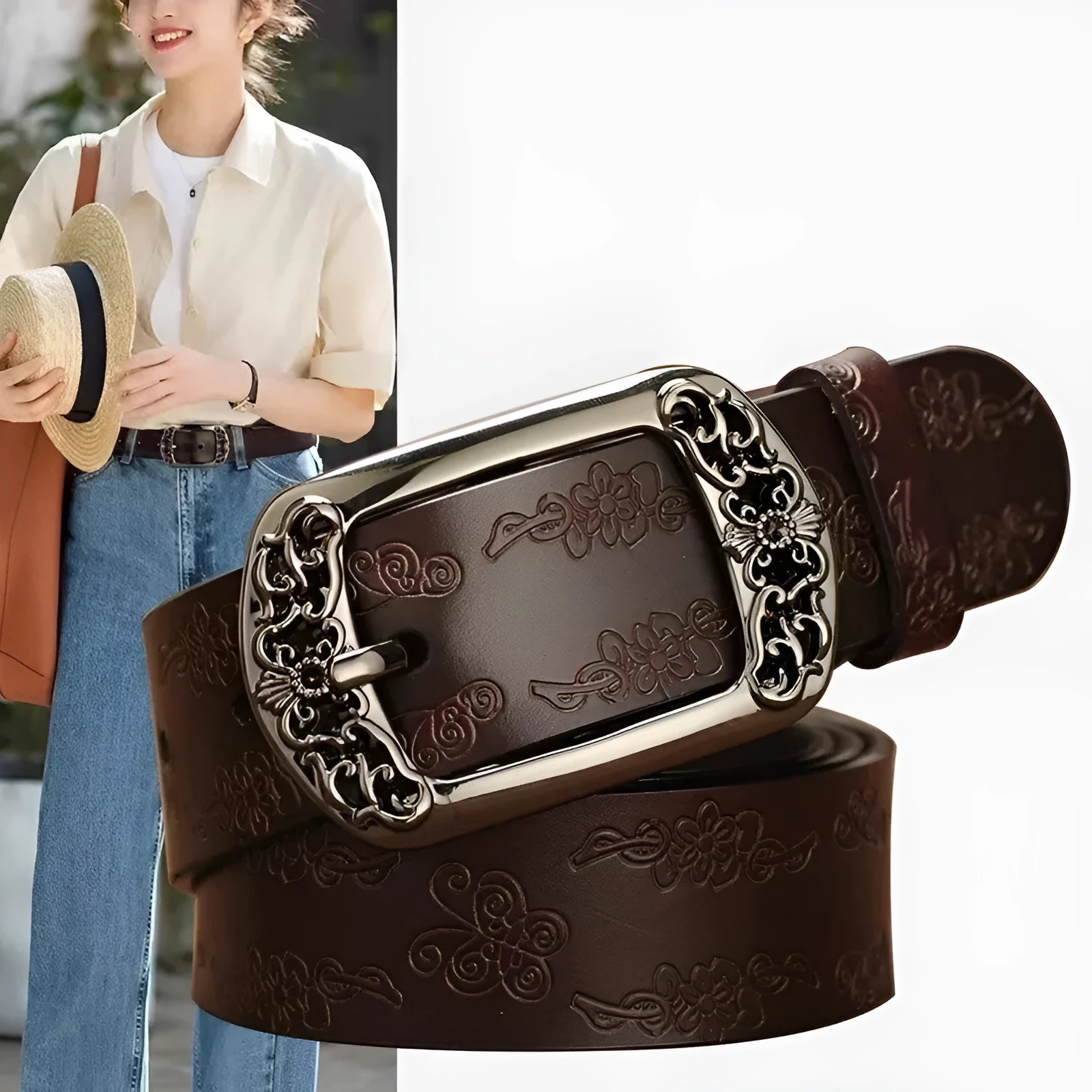 Thin black decorative jeans belt for women with an alloy buckle on a jeans waistband.