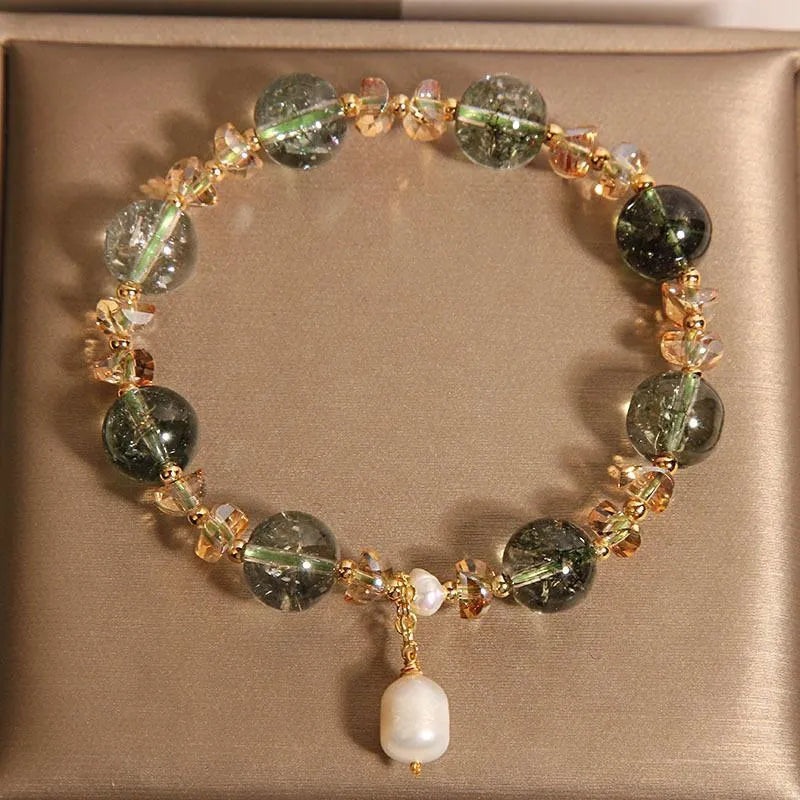 Adjustable green phantom quartz and champagne crystal bead bracelet on a string cord.