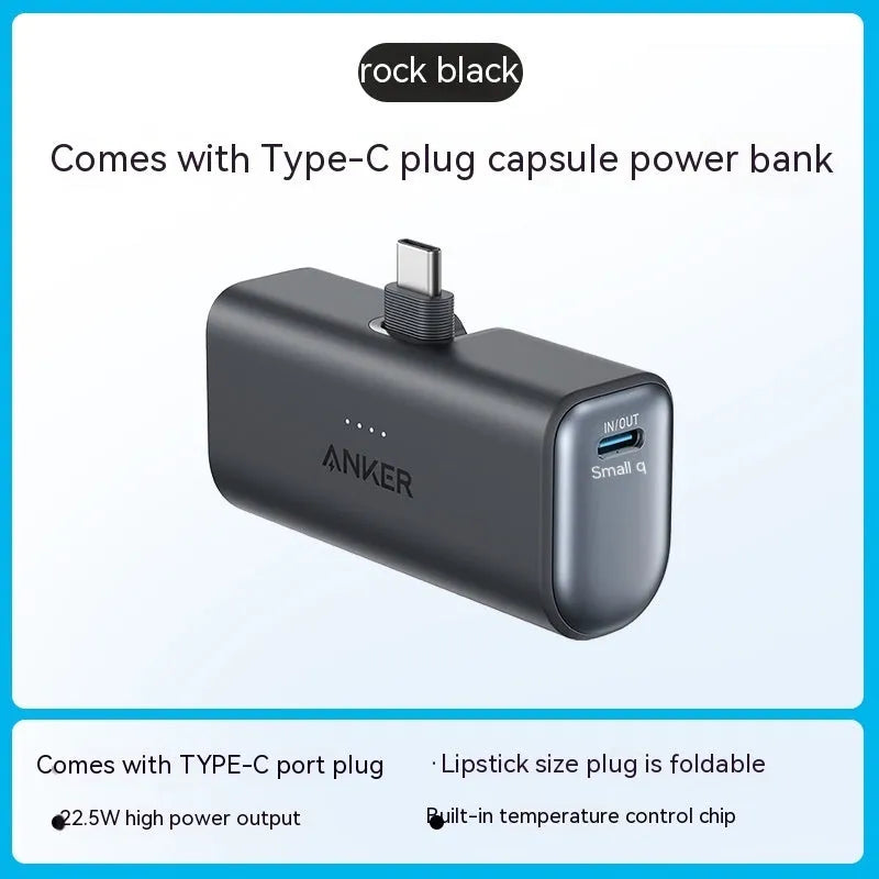 Small capsule-shaped power bank in multiple colours showing built-in foldable USB-C cable and compact size.
