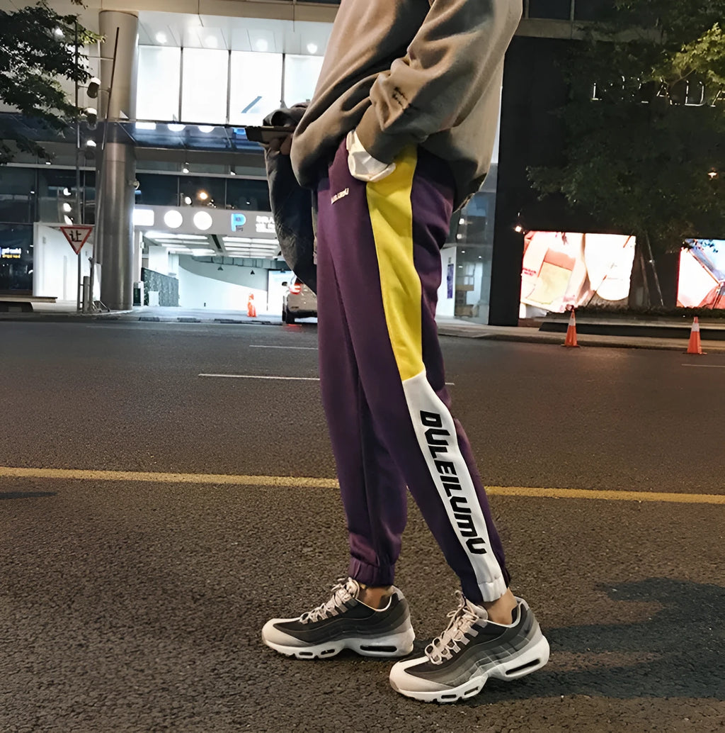 Spring men's casual slim fit sweatpants in black and white printed polyester with zippered pockets and drawstring waist