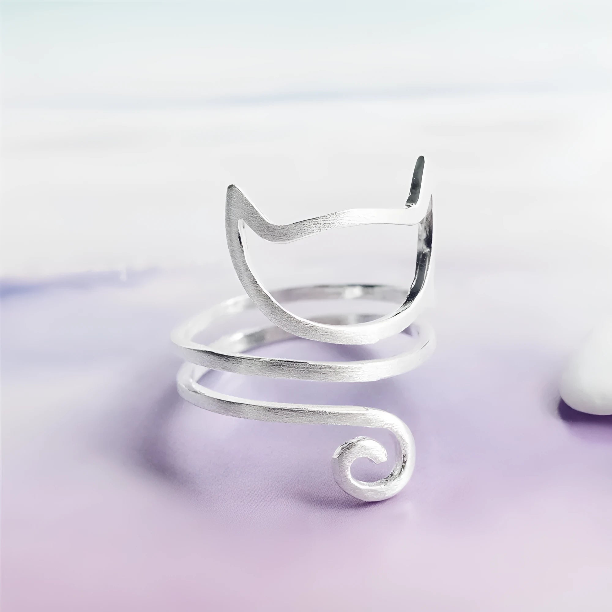 S925 silver adjustable cat ring with brushed winding collar detail on light background