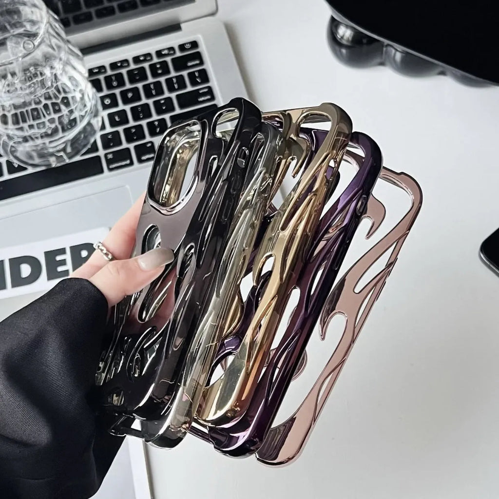 Electroplated hollow flame pattern TPU phone case for iPhone on a table, showing silver metallic finish and ventilation design.