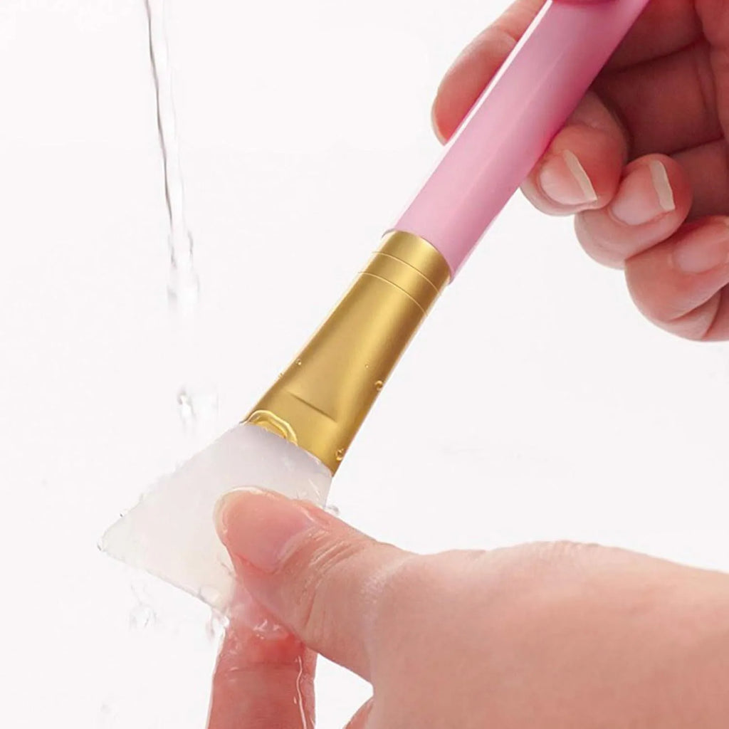 Reusable silicone face and body mask applicator spatula in six colours on a white background.