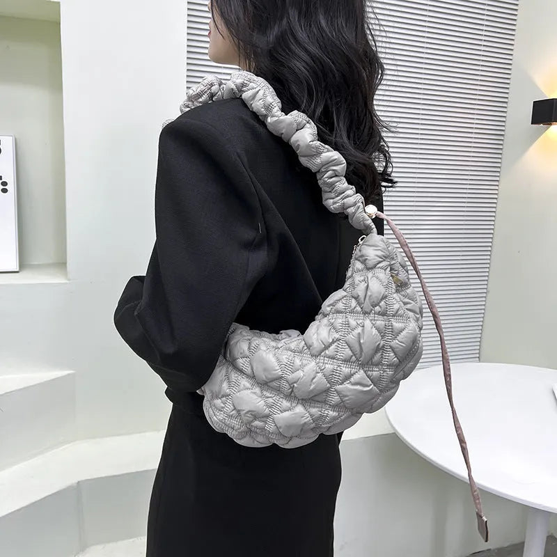 Light beige women's casual nylon shoulder messenger bag with a long adjustable strap.