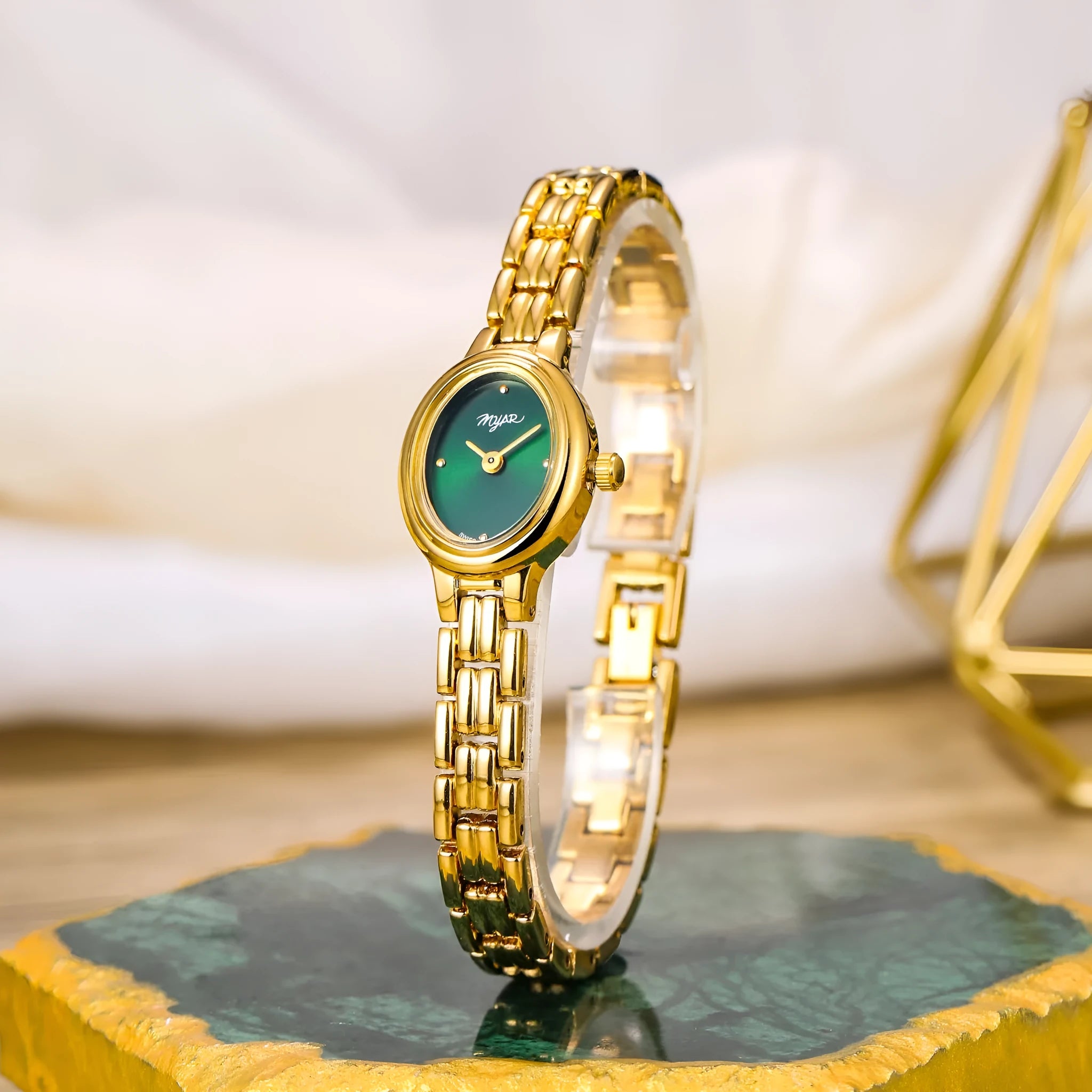 Oval mini women's vintage quartz watch with gold alloy case, white dial, and jewellery buckle