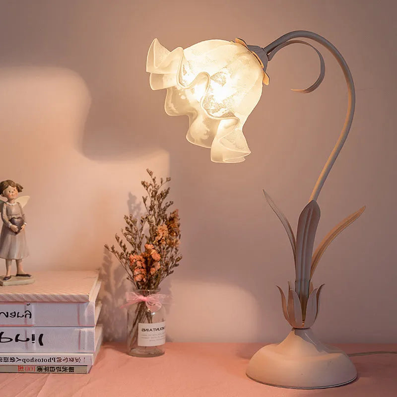 Pink princess room desk lamp with ceramic flowers, glass lampshade, and dimmer switch on a wooden desk