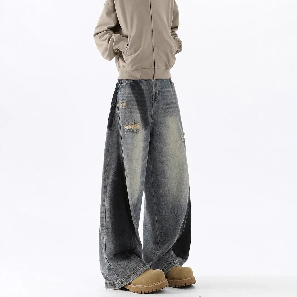 Men's blue distressed jeans with splash-ink patterns and rips in loose fit American style