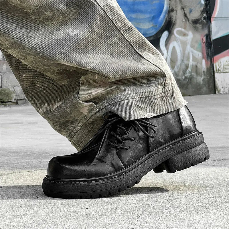 Black low-top platform shoes with round toe cap and rubber sole for men and women.