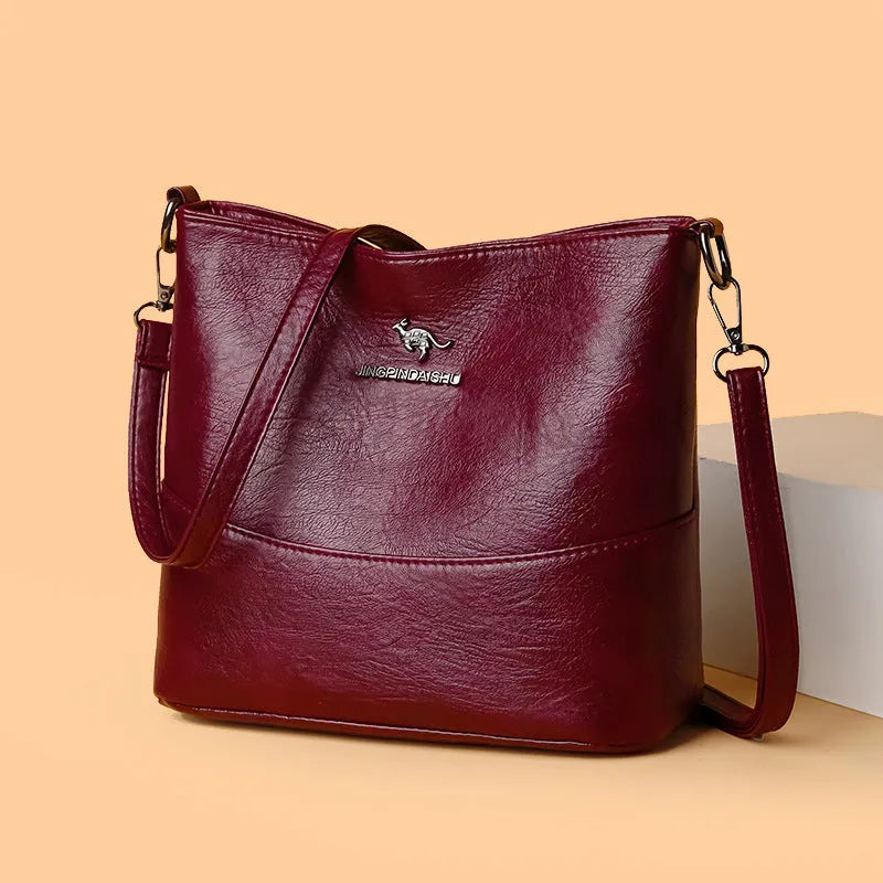 Women's soft leather bucket shoulder bag in black with sewing line detailing and mobile phone pocket
