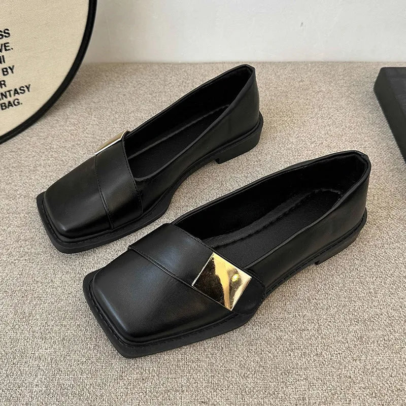 Beige women's square-toe flat shoes with a metal buckle and low rubber sole.