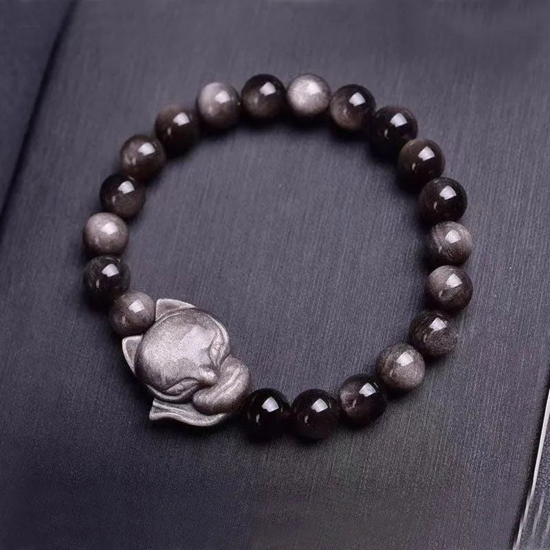 Obsidian fox bracelet with 8mm black stone beads and silver-toned fox charm on wrist