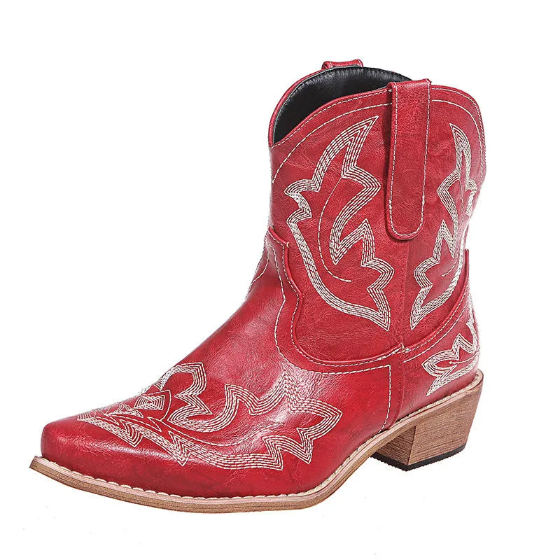 Women's blue embroidered cowboy boots with a wedge heel and pointed toe on a white background.